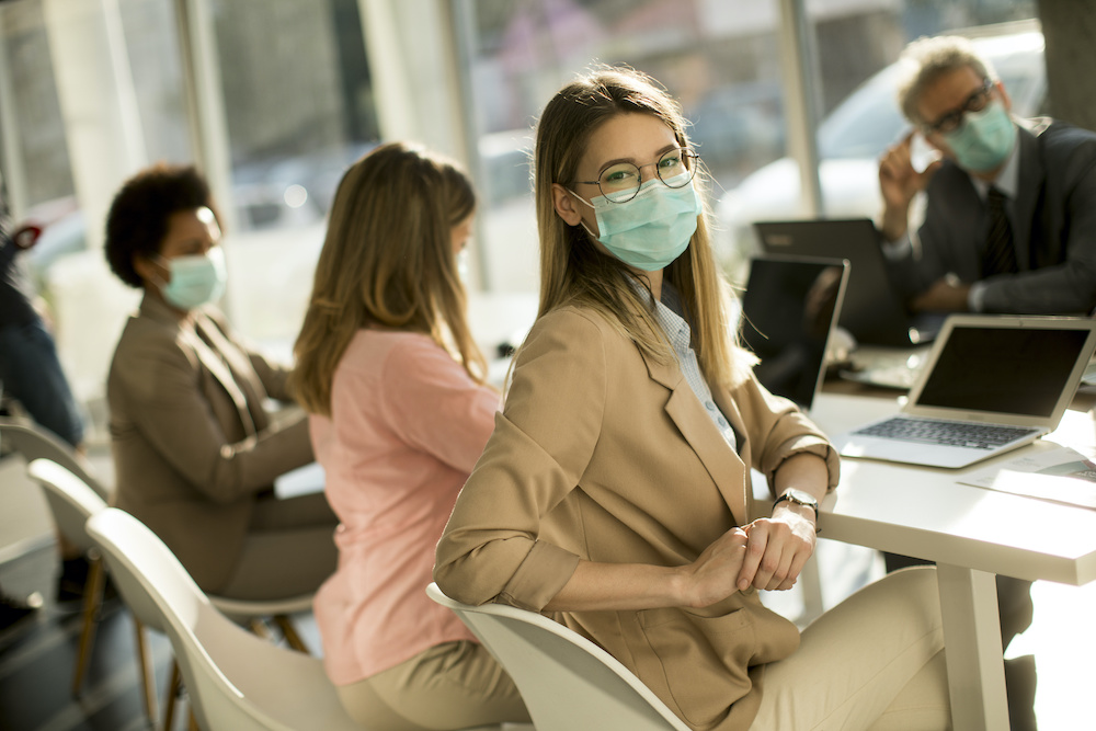 Young woman with group of business people have a meeting and working in office and wear mask as protection from corona virus